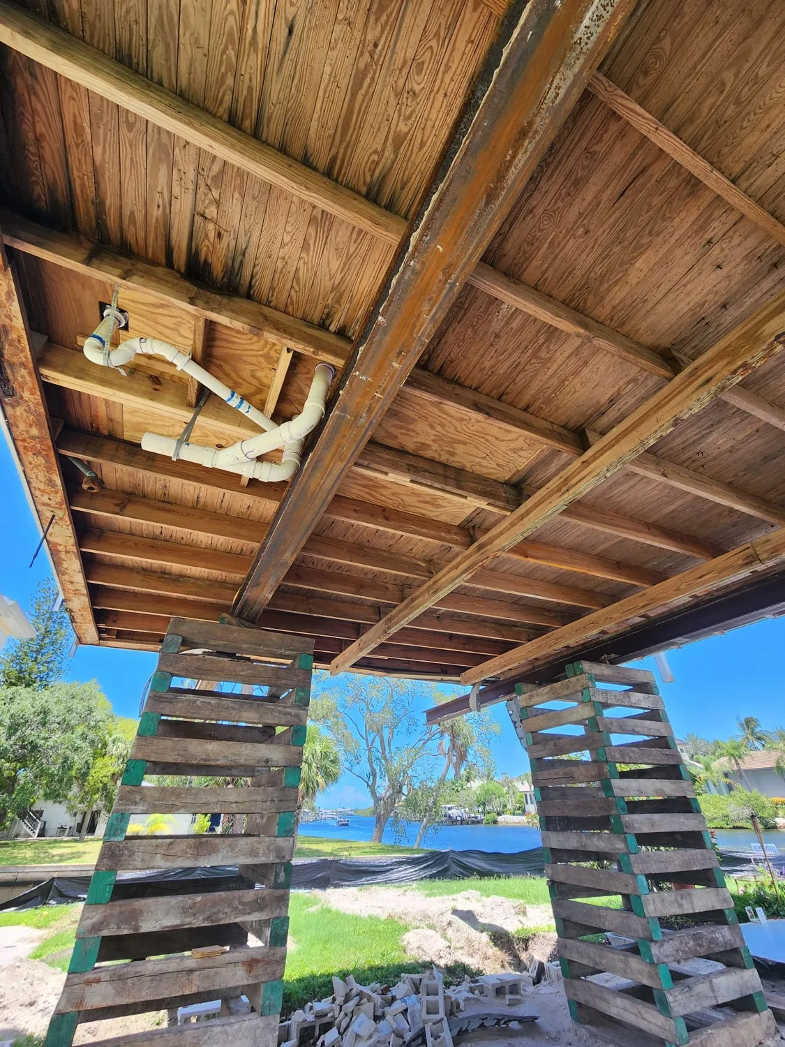 Close-up of flood and rust damage on underside of home structure — showing why elevation is critical